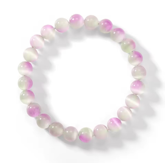 Beaded bracelet with pink and white beads on a white background