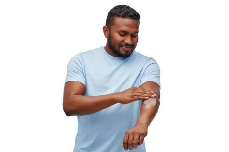 Man applying lotion. 