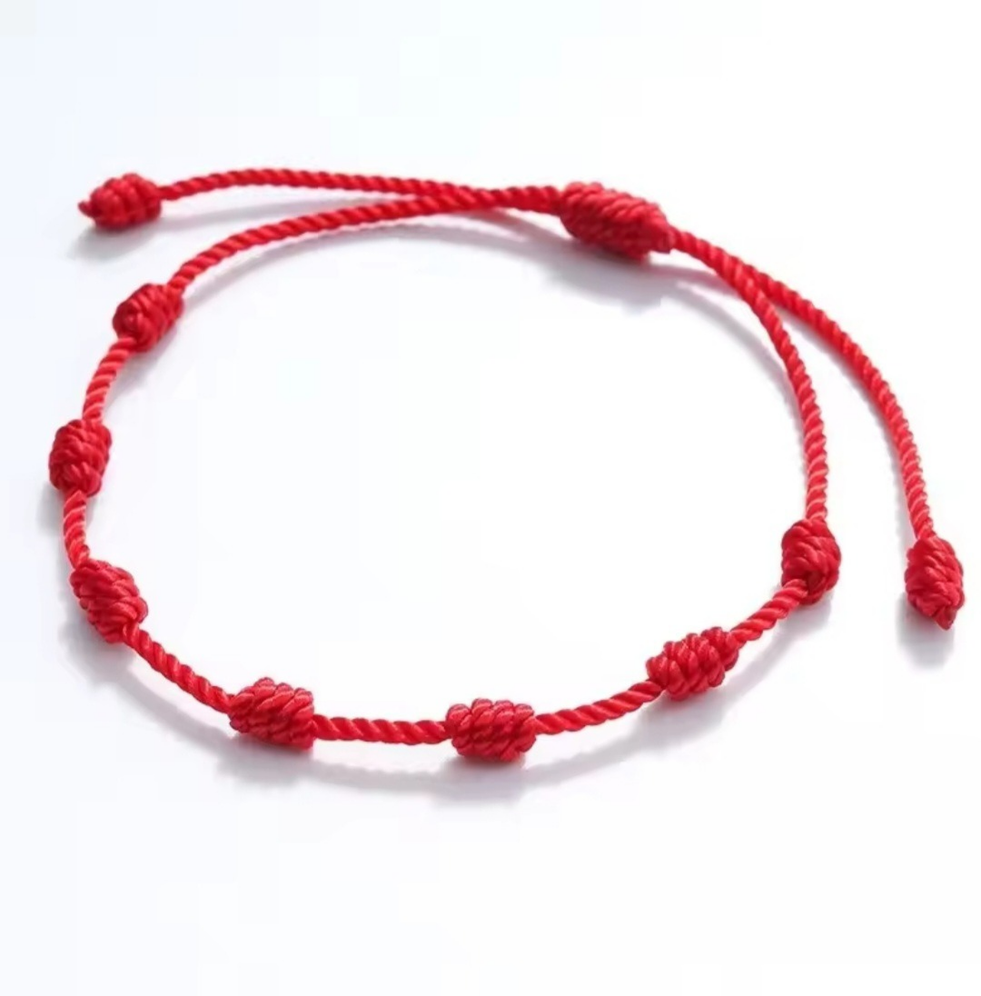 Red knotted bracelet on a white background