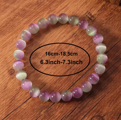 Multicolored beaded bracelet on a wooden surface with measurement text.