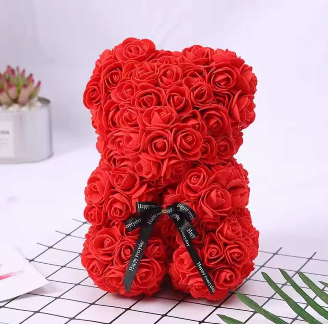 Red rose teddy bear with a black ribbon on a white background