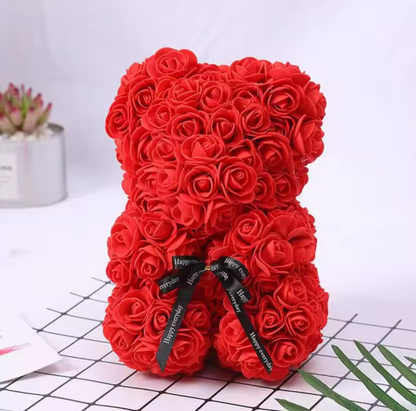 Red rose teddy bear with a black ribbon on a white background
